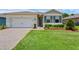 Single-story home with brick paver driveway, two-car garage and a freshly landscaped front yard at 1511 Lyonsdale Ln, Sanford, FL 32771