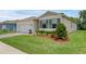 Well maintained home features a green lawn, neutral exterior, and low maintenance landscaping at 1511 Lyonsdale Ln, Sanford, FL 32771