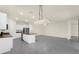 Spacious kitchen with island, white cabinets, gray tile flooring and modern lighting fixtures at 1511 Lyonsdale Ln, Sanford, FL 32771