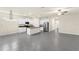 Open kitchen with island, granite counters, stainless steel appliances, and gray tile flooring at 1511 Lyonsdale Ln, Sanford, FL 32771