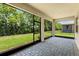 Screened in lanai featuring a brick floor and an expansive view of the yard at 1511 Lyonsdale Ln, Sanford, FL 32771