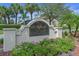 Beautiful sign for The Groves at Baytree community with manicured landscaping and several palm trees at 4581 Marsh Harbor Dr, Tavares, FL 32778