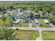 Expansive aerial shot showcasing a waterfront neighborhood with mature trees and access to a serene lake at 5208 Oakdale Rd, Haines City, FL 33844