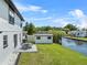 Manicured backyard of a waterfront property showing the yard, patio and a canal at 5208 Oakdale Rd, Haines City, FL 33844
