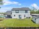View of the backyard with a patio, green lawn, and canal access, offering a private outdoor space at 5208 Oakdale Rd, Haines City, FL 33844