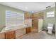 An elegant bathroom featuring a soaking tub, walk-in shower, and toilet at 5208 Oakdale Rd, Haines City, FL 33844