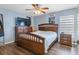 Comfortable bedroom featuring wood flooring, a ceiling fan, and modern furnishings at 5208 Oakdale Rd, Haines City, FL 33844