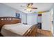 Cozy bedroom with light blue walls, wood flooring, ceiling fan, and a closet at 5208 Oakdale Rd, Haines City, FL 33844