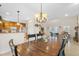 An elegant dining area with a wooden table, pendant lighting, and an open view of the kitchen at 5208 Oakdale Rd, Haines City, FL 33844