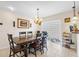 Bright dining space with a large table, modern lighting, and easy access to the kitchen at 5208 Oakdale Rd, Haines City, FL 33844