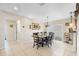 Bright dining room with tile flooring, dark wood table set, and a large sliding glass door at 5208 Oakdale Rd, Haines City, FL 33844