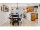 Well-lit dining room featuring a wooden table and a smooth transition into the kitchen area at 5208 Oakdale Rd, Haines City, FL 33844