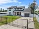 View of a lovely home with a black fence, offering both curb appeal and security at 5208 Oakdale Rd, Haines City, FL 33844