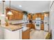 Cozy kitchen with wood cabinets, a practical layout, and modern appliances, ideal for Gathering meals at 5208 Oakdale Rd, Haines City, FL 33844