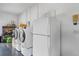 Laundry room featuring a washer, dryer, and refrigerator at 5208 Oakdale Rd, Haines City, FL 33844