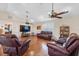 Spacious living room with vaulted ceilings, wood floors, ceiling fans, and ample seating at 5208 Oakdale Rd, Haines City, FL 33844
