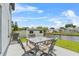 Back patio with outdoor seating and canal view, perfect for relaxation and outdoor dining at 5208 Oakdale Rd, Haines City, FL 33844