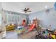 Spacious playroom with colorful decor, wood floors, ceiling fan, and plenty of natural light at 5208 Oakdale Rd, Haines City, FL 33844