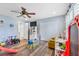 Well-lit playroom with wood floors, ceiling fan, and an organized layout at 5208 Oakdale Rd, Haines City, FL 33844