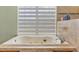 Close up of a soaking tub, and large window at 5208 Oakdale Rd, Haines City, FL 33844