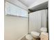 Clean bathroom showcases a shower with modern curtain and fixtures with a bright window view at 1007 Gammage Pt, Oviedo, FL 32765