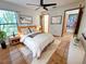 Inviting bedroom with stylish decor, a ceiling fan, and ample natural light from the window at 1007 Gammage Pt, Oviedo, FL 32765