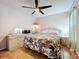 Cozy bedroom featuring stylish furniture, tile floor, and a cooling ceiling fan at 1007 Gammage Pt, Oviedo, FL 32765