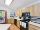 Efficient kitchen featuring stainless steel appliances, wooden cabinets, and a door to the patio at 1007 Gammage Pt, Oviedo, FL 32765
