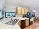 Well-lit kitchen featuring stainless steel appliances, wooden cabinets, and sink with window view at 1007 Gammage Pt, Oviedo, FL 32765