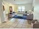 Inviting living room with large windows, plush seating, and neutral tones, creating a cozy and bright atmosphere at 1007 Gammage Pt, Oviedo, FL 32765