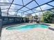 Kidney shaped pool in a screened in enclosure at 1007 Gammage Pt, Oviedo, FL 32765