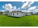 The backyard has a well-manicured lawn and a covered patio area for outdoor relaxation and entertaining at 12950 Sw 38Th Cir, Ocala, FL 34473