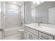 A well-lit bathroom featuring a sleek vanity, modern fixtures, and a tiled shower at 12950 Sw 38Th Cir, Ocala, FL 34473