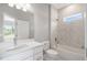 This bathroom features a shower/tub combination with marble-style tiles and a white vanity at 12950 Sw 38Th Cir, Ocala, FL 34473