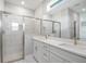 Modern bathroom with a walk-in shower, double sinks, and a large mirror at 12950 Sw 38Th Cir, Ocala, FL 34473