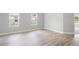 Neutral bedroom with wood-look flooring and a large window for natural light at 12950 Sw 38Th Cir, Ocala, FL 34473