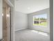 Bright, carpeted bedroom with ample natural light and neutral wall color at 12950 Sw 38Th Cir, Ocala, FL 34473