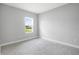 Bright bedroom featuring a window, neutral carpet, and a fresh, clean aesthetic at 12950 Sw 38Th Cir, Ocala, FL 34473