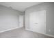 A serene bedroom with plush carpeting and closet doors that maximize storage space at 12950 Sw 38Th Cir, Ocala, FL 34473