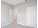 Comfortable bedroom with neutral carpeting, two doors and a light, airy ambiance at 12950 Sw 38Th Cir, Ocala, FL 34473