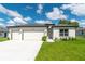 Charming single-story home featuring a three-car garage and well-maintained lawn at 12950 Sw 38Th Cir, Ocala, FL 34473