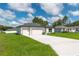 Charming single-story home featuring a three-car garage, well-maintained lawn, and neutral color scheme at 12950 Sw 38Th Cir, Ocala, FL 34473