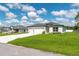 A well-manicured lawn leads up to this single Gathering home with a three-car garage at 12950 Sw 38Th Cir, Ocala, FL 34473