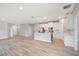 This kitchen features stainless steel appliances, a white island, and hardwood floors at 12950 Sw 38Th Cir, Ocala, FL 34473