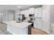 This kitchen has stainless steel appliances, white cabinets, and an island at 12950 Sw 38Th Cir, Ocala, FL 34473