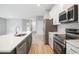 Modern kitchen featuring stainless steel appliances, white cabinets, and quartz countertops at 12950 Sw 38Th Cir, Ocala, FL 34473