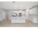 This kitchen boasts stainless steel appliances, a white island, and hardwood floors at 12950 Sw 38Th Cir, Ocala, FL 34473