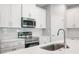 This kitchen boasts stainless steel appliances and modern white cabinets at 12950 Sw 38Th Cir, Ocala, FL 34473