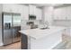 This kitchen has stainless steel appliances, white cabinets, and an island at 12950 Sw 38Th Cir, Ocala, FL 34473