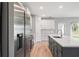 This kitchen has stainless steel appliances, a white island, and hardwood floors at 12950 Sw 38Th Cir, Ocala, FL 34473